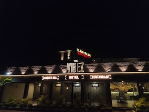A building with a sign that reads 'The Vibez' and 'Kaidikhan Restaurant.' It has a brick facade and a balcony area. - Hotel The Vibez Inn (Jabalpur)