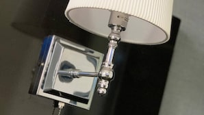 A lamp with a white ribbed shade and a metallic base with a switch. - 3 Bed Apartment at a Central Location (Ibadan)