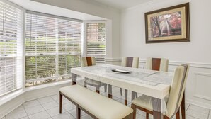 A dining area with a table, chairs, and a bench.