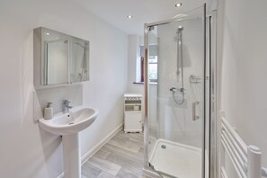 Shower, hair dryer, towels, shampoo