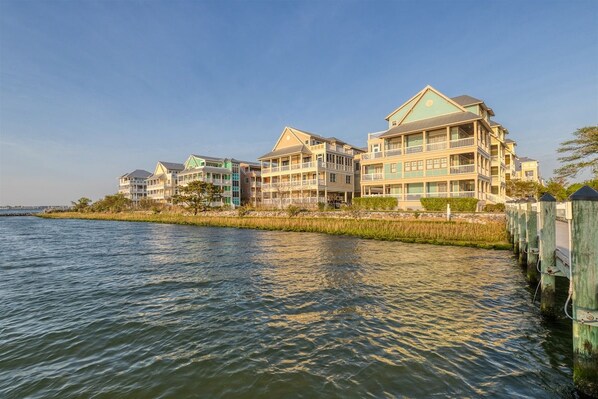 A waterfront hotel with multiple balconies, a dock, and a clear view of the water. - Sunset Island 43 Sunset Island Drive (Ocean City)