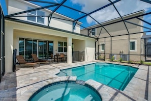 A swimming pool with a glass enclosure, lounge chairs, and a patio area. - Orlando Newest Resort Villa With Pool 1791spp 4 Bedroom Home (Kissimmee)