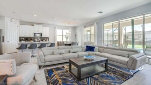 A modern living room with a sectional sofa, a coffee table, and a patterned rug. - Orlando Newest Resort Villa With Pool 1791spp 4 Bedroom Home (Kissimmee)