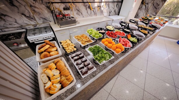 A buffet with various food items including fruits, vegetables, and baked goods. - Koçaklar Otel (Karapınar)