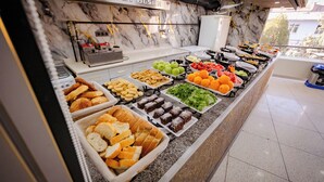 A buffet with various food items including fruits, vegetables, and pastries. - Koçaklar Otel (Karapınar)