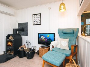 A cozy living room with a fireplace, a television, and a comfortable seating area.