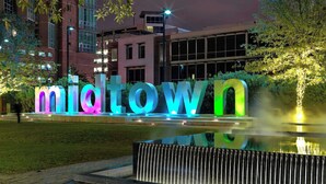 Illuminated 'midtown' letters in a park setting with modern buildings in the background. - NRG Medcenter 2BD 2 5BA w Fencedyard Washerdryer (Houston)