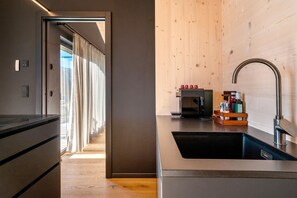 Fridge, stovetop, dishwasher, coffee/tea maker