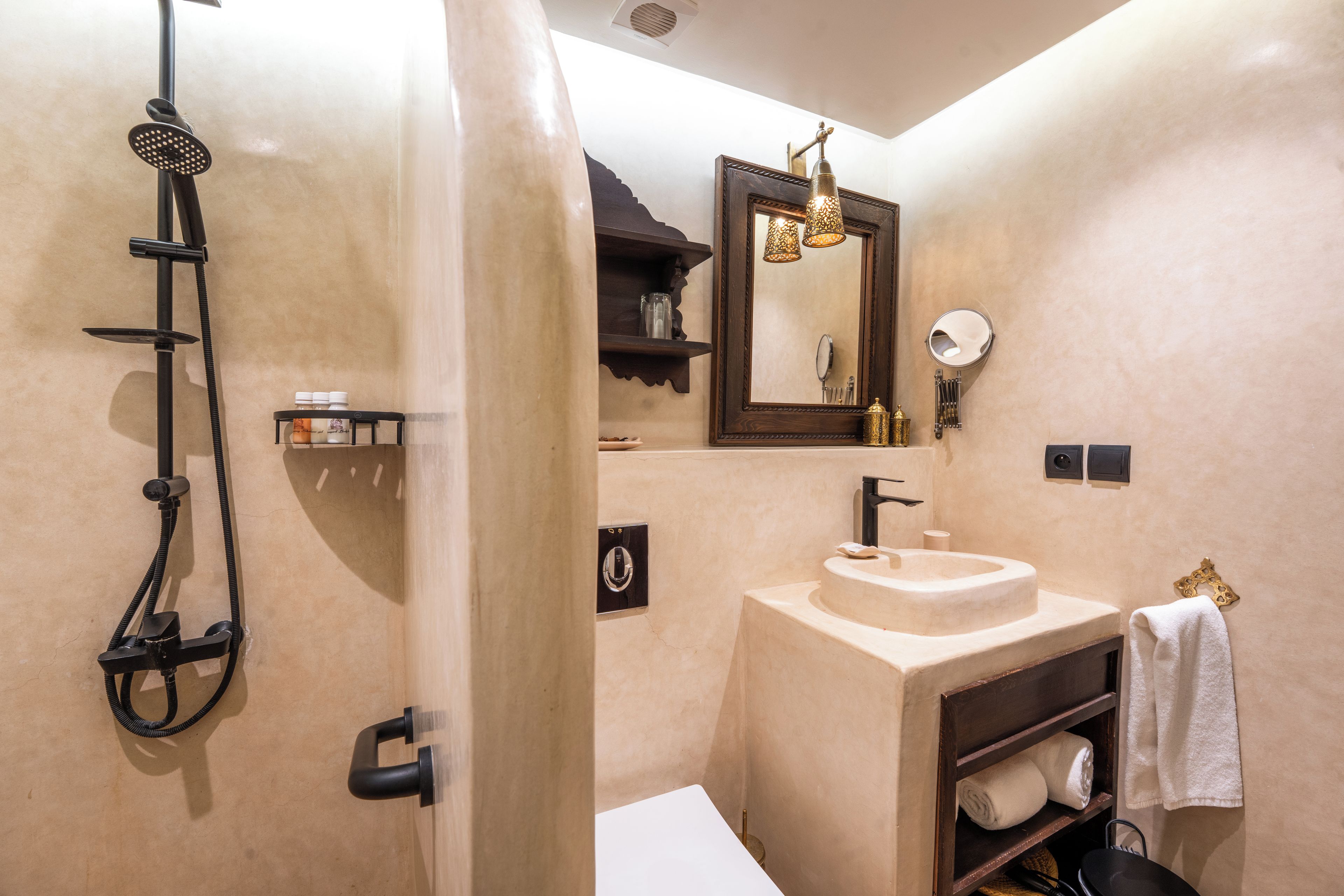 A bathroom with a shower, sink, and mirror.