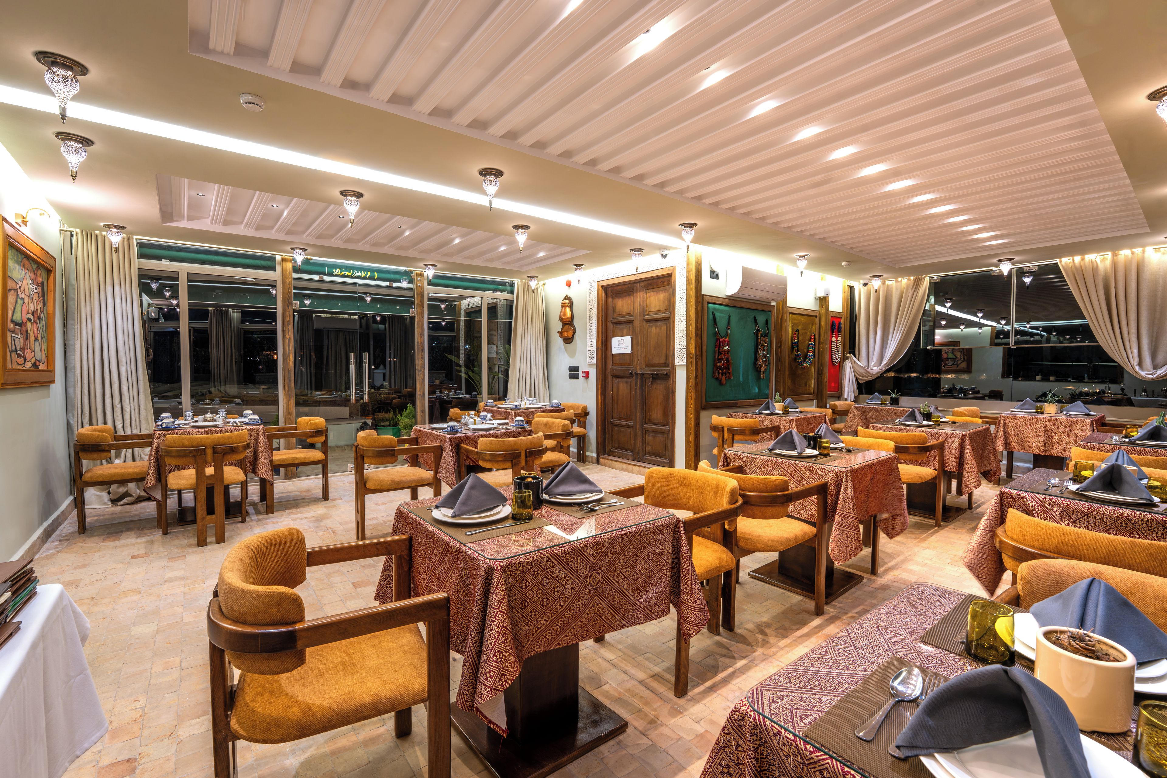 A restaurant with multiple tables, chairs, and a dining area.