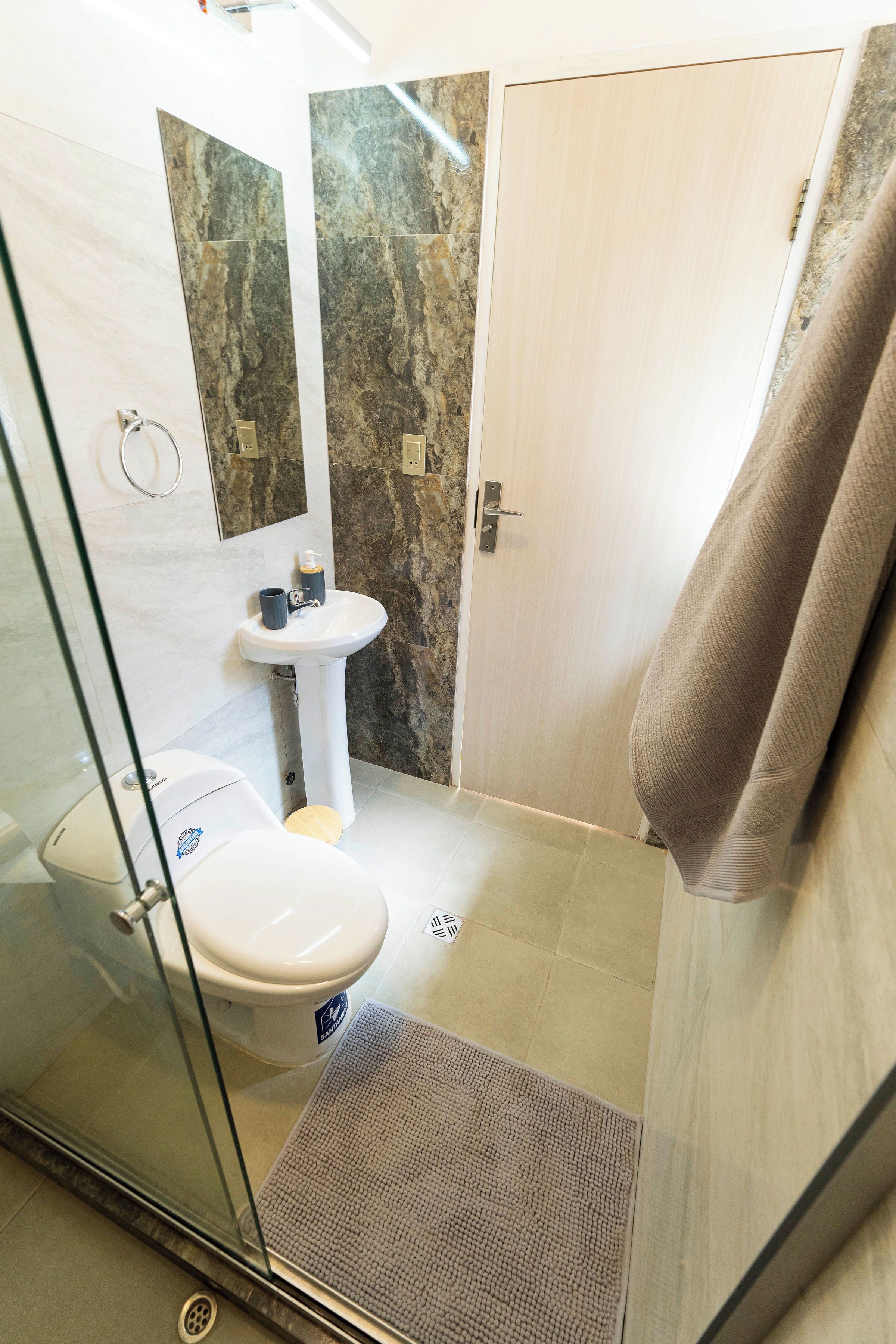 Een douche, handdoeken, zeep, toiletpapier