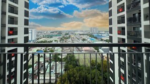 A high-rise building with multiple balconies, each featuring a red flag. - New Lavida (Ho Chi Minh City)