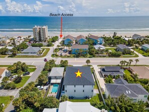 A residential area with a prominent building marked by a yellow star, a beach access point, and a view of the ocean. - Flip Flop Living North (New Smyrna Beach)