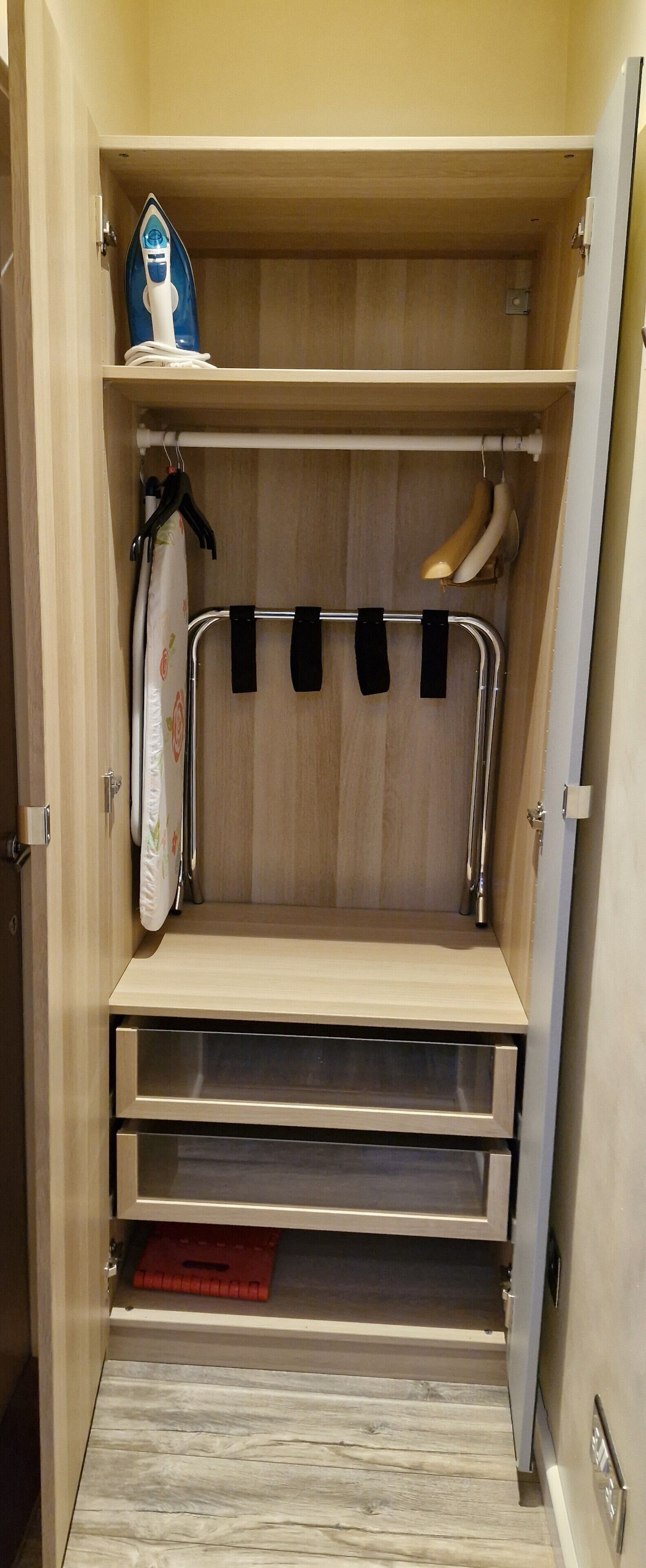 A walk-in closet with shelves, hanging space, and drawers.
