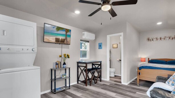 A compact hotel room with a kitchenette, a dining area, and a bed. - Central Tucson Studio Paradise (Tucson)