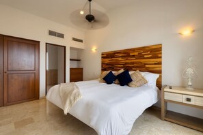 A bedroom with a large bed, wooden headboard, bedside tables, and a wardrobe. - Casa Maravilla - Walk to Beach & Art District. (San José del Cabo)