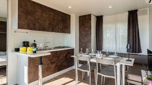 Una cocina moderna con una isla central, una mesa de comedor y sillas.