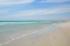 A beach with a clear sky and calm sea.