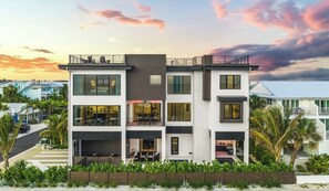 A multi-story building with balconies, large windows, and a flat roof.