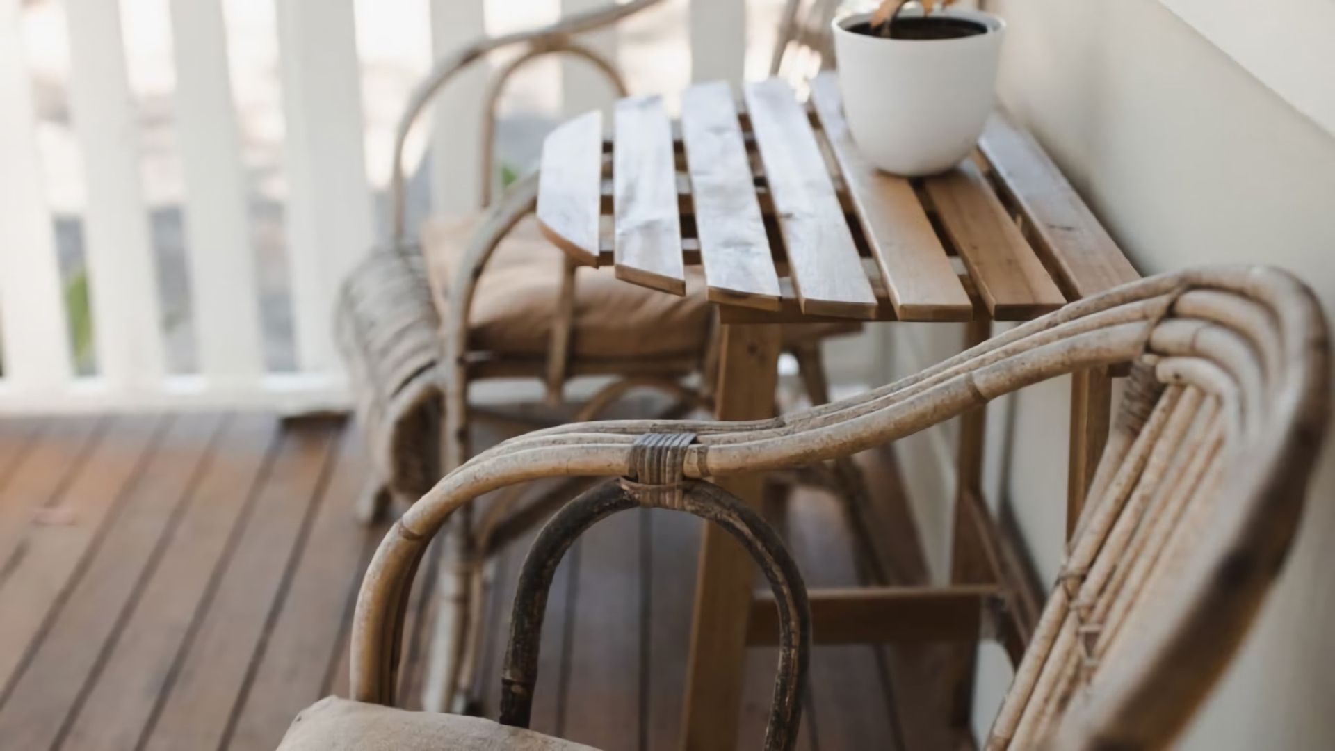 A wooden deck with a table and chairs.