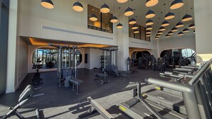 A spacious gym with multiple treadmills, weight machines, and free weights. - Luxury View-Modern 1-BR Condo with Panoramic Ocean Views, Pool & Gym–Miami Beach (Miami Beach)