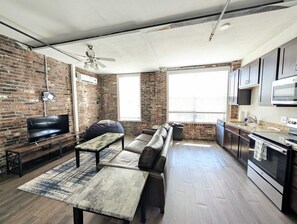 A modern kitchen with a built-in oven and a dining area with a bench and table.