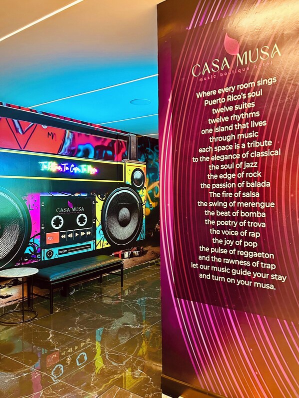 A vibrant room with a large speaker and a neon sign. - Stay @La Placita with us and dive into Puerto Rico's #1 cultural hotspot. (San Juan)