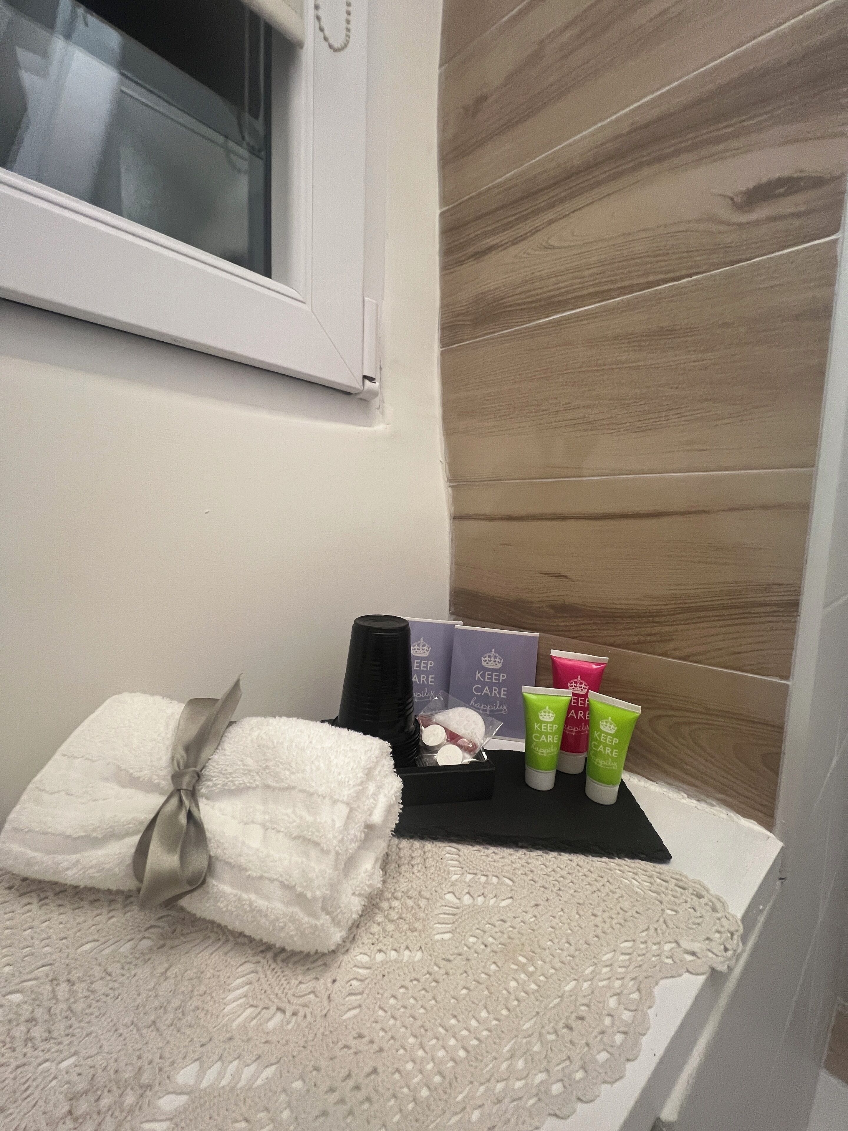 A bathroom vanity with a towel, toiletries, and a decorative item.