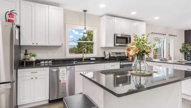 A modern kitchen with white cabinets, stainless steel appliances, a central island, and a view of the outdoors. - Sauna, Theatre, Game Room, Gym, EV Chrger, Firepit (Toms Brook)