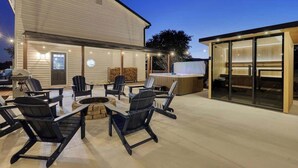 An outdoor patio with seating and a hot tub. - Sauna, Theatre, Game Room, Gym, EV Chrger, Firepit (Toms Brook)