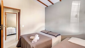 A hotel room with two beds, a wooden ceiling, and a large window. - Casa Ilha de Sol (Ilhabela)