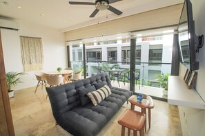 Comfort Apartment, 1 King Bed with Sofa bed, Balcony | Living area | 45-inch flat-screen TV with digital channels - Ipana by The Spot Rentals (Playa del Carmen)