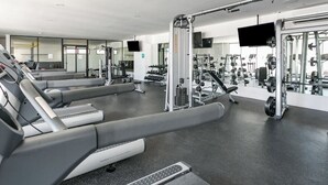A modern gym with treadmills, weight machines, and free weights. - Ipana by The Spot Rentals (Playa del Carmen)