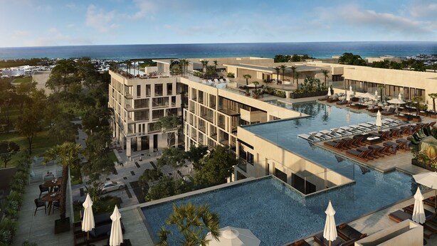 A modern hotel with a rooftop pool, multiple balconies, and a view of the ocean. - Ipana by The Spot Rentals (Playa del Carmen)