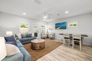 This inviting open-concept living area combines comfort and style with cozy furnishings, tasteful décor, and plenty of natural light—perfect for relaxing or entertaining. - Towne Treasures B ~ Brand-New Luxe Coastal Retreat with Private Cocktail Pool (Panama City Beach)