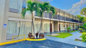 A multi-story hotel with a flat facade, large windows, and a balcony on the second floor. - River Palm Hotel (Melbourne)