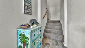 A staircase with a wooden handrail and a light-colored wall.