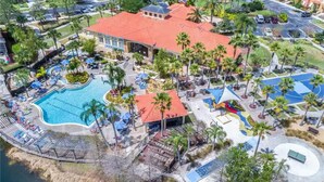 An aerial view of a resort with a swimming pool, a basketball court, and palm trees. - Enjoy all the Theme Parks and what Orlando has to offer at Terra Verde Resort! (Kissimmee)