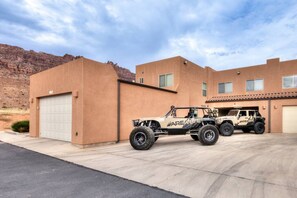 A two-story building with a garage and a driveway. - Adventure-Ready With Room For All Of Your Toys (Moab)