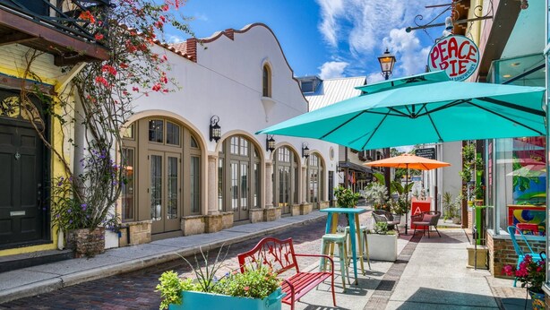 A quaint street with a café named "Peace Pie" offering sandwiches.