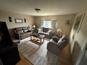 A living room with a sofa, armchairs, a coffee table, and a television. - Cozy Mountain retreat in Sargents, 17 minutes to Monarch Ski Area. Pet friendly (Sargents)