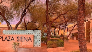 Plaza Siena -kyltti, taustalla moderni rakennus.