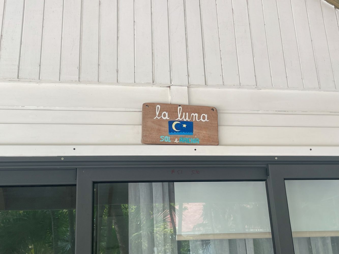 A sign with the text "la luna" and a moon symbol, indicating a possible name or theme of the establishment.