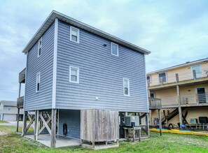 A two-story building with a flat roof and a covered outdoor area. - Hoff 1 by Topsail Realty (Holly Ridge)