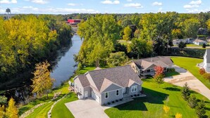 A residential area with houses, a river, and a water tower. - River’s Bend Sanctuary- WALK to Beach & Downtown (Caseville)
