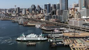 A waterfront cityscape with a prominent Ferris wheel, high-rise buildings, and a large cruise ship docked at a pier. - Modern West Seattle Home with View, 3bed, 2.5bath, AC, 2Parking (Seattle)