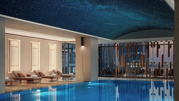A modern indoor pool with a starry ceiling, lounge chairs, and large windows. - JW Marriott Hotel Tashkent (Tashkent)