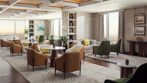 A modern hotel lobby with a high ceiling, geometric ceiling design, and large windows offering city views. - JW Marriott Hotel Tashkent (Tashkent)