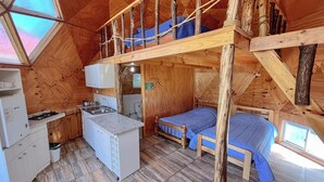 A compact wooden cabin with a loft bedroom, a kitchenette, and a bathroom. - DOmos Ocoa (Hijuelas)