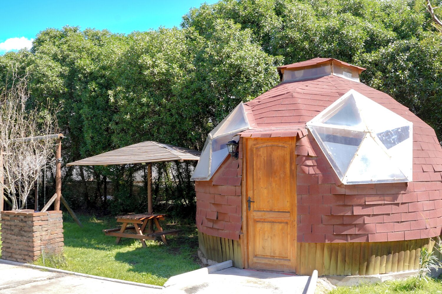 A small, rustic cabin with a wooden door and a sloped roof.